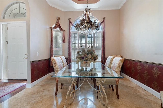 2232 Lake Vilma Dr, Orlando, FL 32835 - dining area featuring baseboards, ornamental molding, a raised ceiling, and a notable chandelier