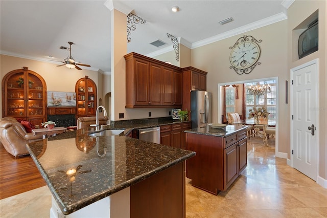 2232 Lake Vilma Dr, Orlando, FL 32835 - kitchen featuring crown molding, a sink, stainless steel appliances, a kitchen island, and visible vents