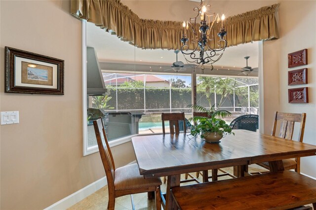 2232 Lake Vilma Dr, Orlando, FL 32835 - dining room featuring baseboards and ceiling fan with notable chandelier