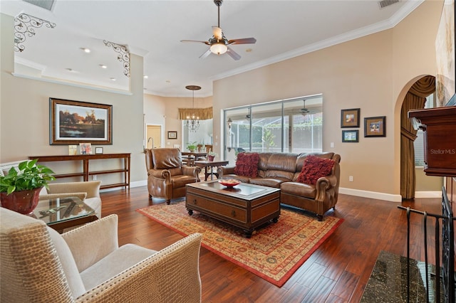 2232 Lake Vilma Dr, Orlando, FL 32835 - living room with arched walkways, baseboards, ornamental molding, and ceiling fan with notable chandelier