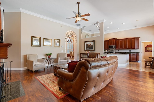 2232 Lake Vilma Dr, Orlando, FL 32835 - living room featuring crown molding, ceiling fan, baseboards, and hardwood / wood-style floors