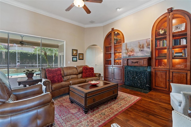 2232 Lake Vilma Dr, Orlando, FL 32835 - living area featuring a premium fireplace, a ceiling fan, arched walkways, and dark wood-type flooring