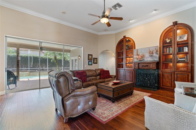 2232 Lake Vilma Dr, Orlando, FL 32835 - living area featuring visible vents, ceiling fan, dark wood-style floors, a high end fireplace, and arched walkways