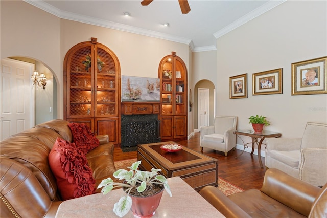 2232 Lake Vilma Dr, Orlando, FL 32835 - living area with crown molding, ceiling fan, arched walkways, wood finished floors, and a high end fireplace