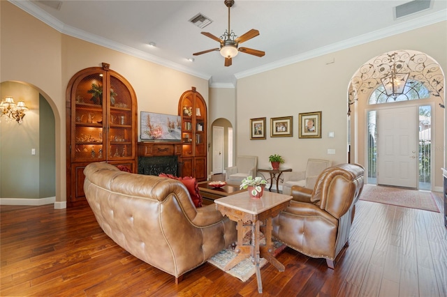 2232 Lake Vilma Dr, Orlando, FL 32835 - living area with crown molding, arched walkways, a ceiling fan, and visible vents