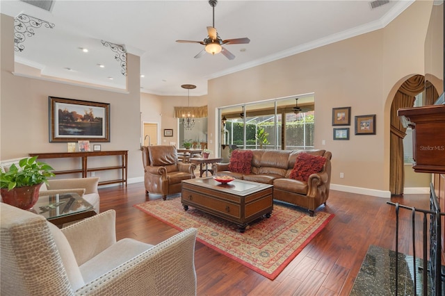 2232 Lake Vilma Dr, Orlando, FL 32835 - living room featuring baseboards, crown molding, ceiling fan with notable chandelier, and arched walkways