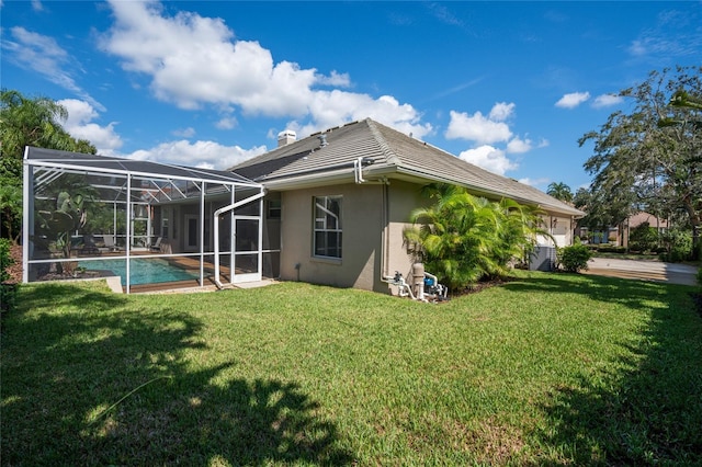 2232 Lake Vilma Dr, Orlando, FL 32835 - back of house with a garage, stucco siding, an outdoor pool, a lawn, and glass enclosure