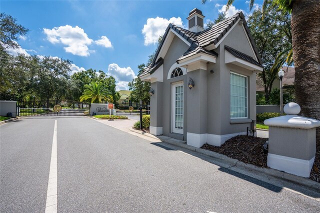 2232 Lake Vilma Dr, Orlando, FL 32835 - view of side of property featuring a gate, stucco siding, and fence