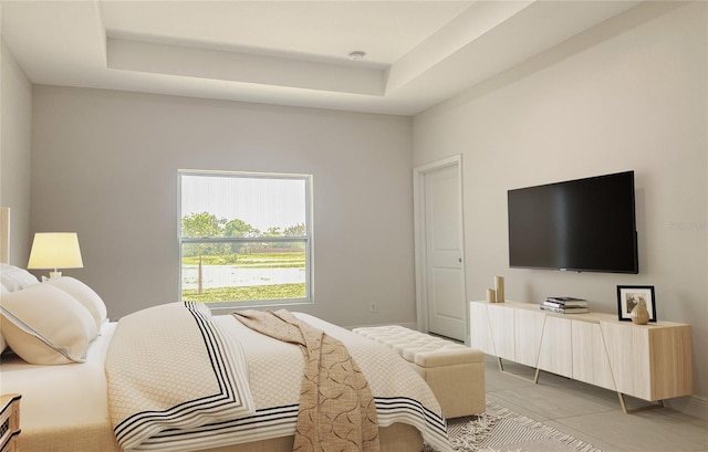 bedroom featuring light tile patterned floors and a raised ceiling