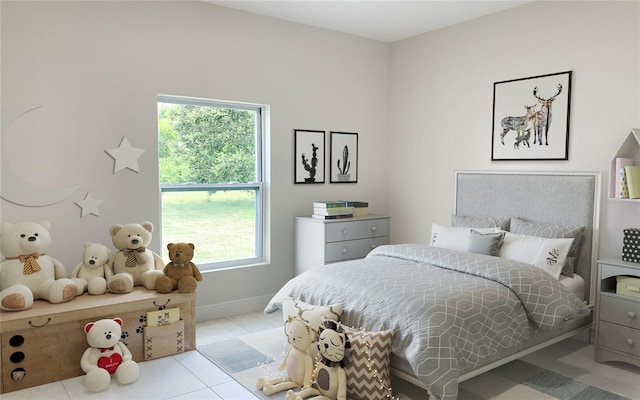 bedroom with baseboards and light tile patterned flooring