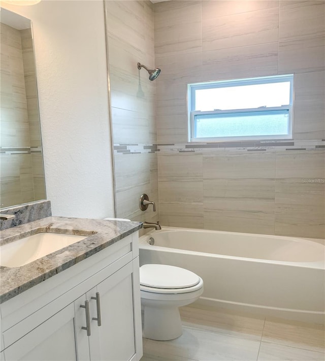 full bathroom featuring vanity, washtub / shower combination, and toilet