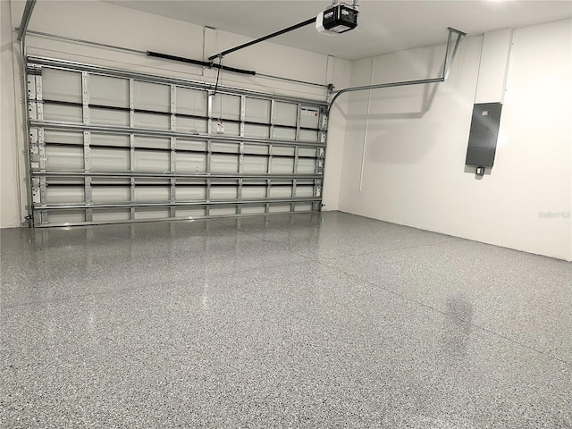 garage with a garage door opener and electric panel