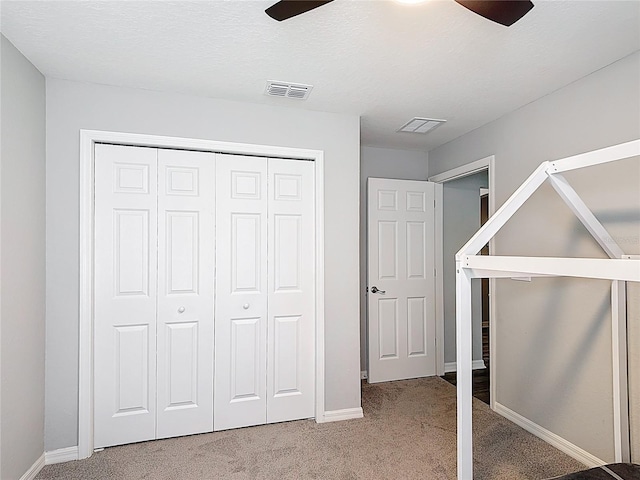 2005 Noble Dr, Davenport, FL 33837 - unfurnished bedroom with carpet, a closet, baseboards, and ceiling fan