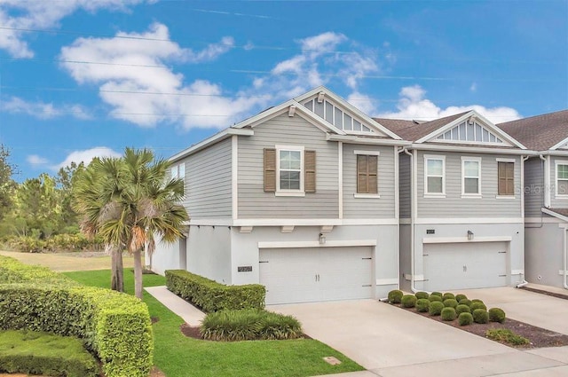 view of front of house with an attached garage, stucco siding, and concrete driveway