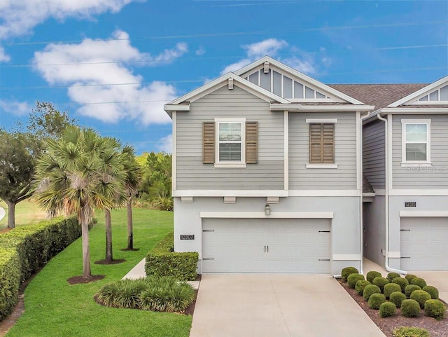 view of front facade featuring an attached garage, stucco siding, driveway, and a front yard