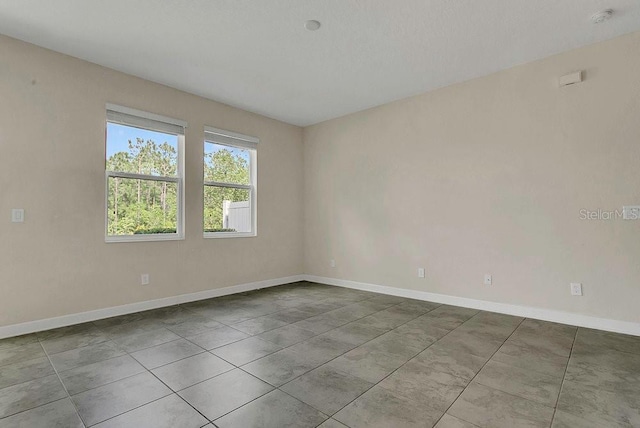 spare room featuring baseboards