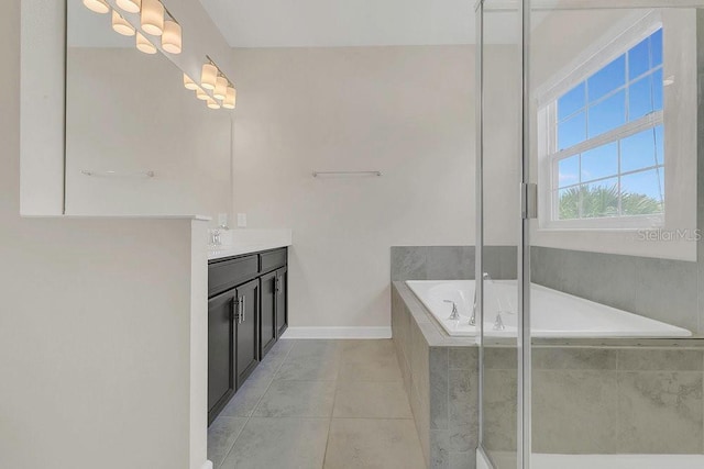 bathroom with a garden tub, baseboards, tile patterned flooring, and vanity