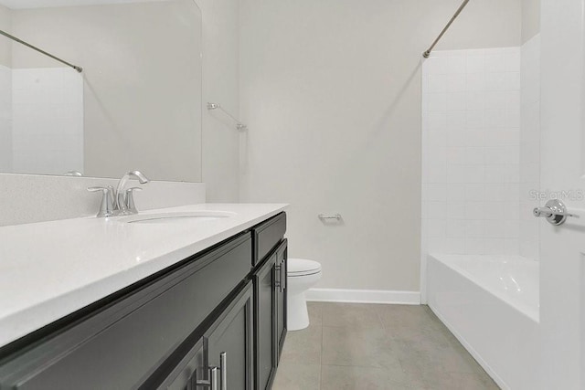bathroom featuring vanity, toilet, baseboards, washtub / shower combination, and tile patterned floors