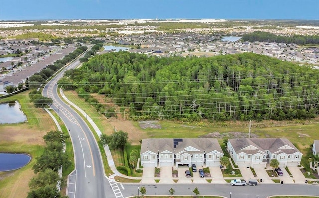 birds eye view of property featuring a water view and a residential view