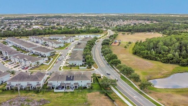 birds eye view of property with a water view and a residential view
