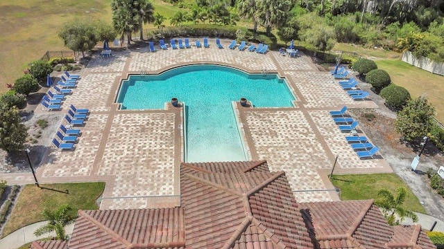 pool featuring fence and a patio area