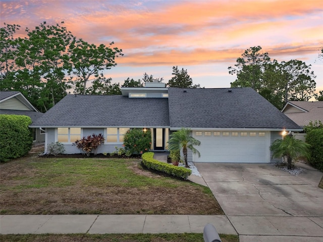2260 Winslow Cir, Casselberry, FL 32707 - view of front facade with driveway, a front lawn, roof with shingles, and a garage