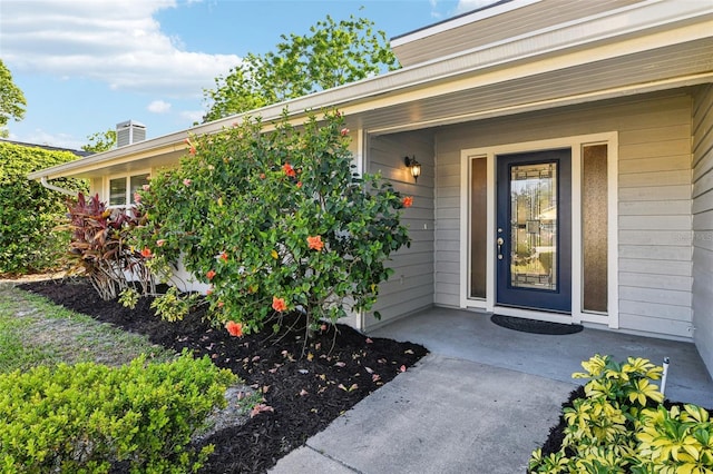 2260 Winslow Cir, Casselberry, FL 32707 - view of exterior entry with a porch and a chimney