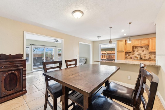 2260 Winslow Cir, Casselberry, FL 32707 - dining area featuring light tile patterned flooring, ceiling fan, and a textured ceiling