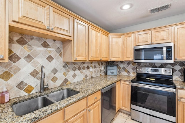 2260 Winslow Cir, Casselberry, FL 32707 - kitchen with visible vents, a sink, appliances with stainless steel finishes, and light stone counters