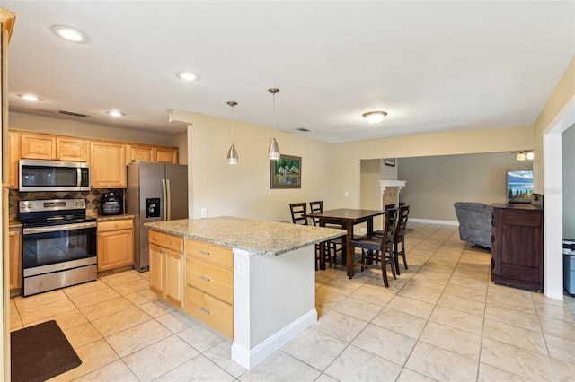 2260 Winslow Cir, Casselberry, FL 32707 - kitchen with decorative backsplash, light brown cabinetry, light tile patterned flooring, decorative light fixtures, and stainless steel appliances