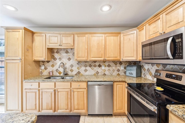 2260 Winslow Cir, Casselberry, FL 32707 - kitchen with a sink, appliances with stainless steel finishes, light brown cabinetry, and light stone countertops