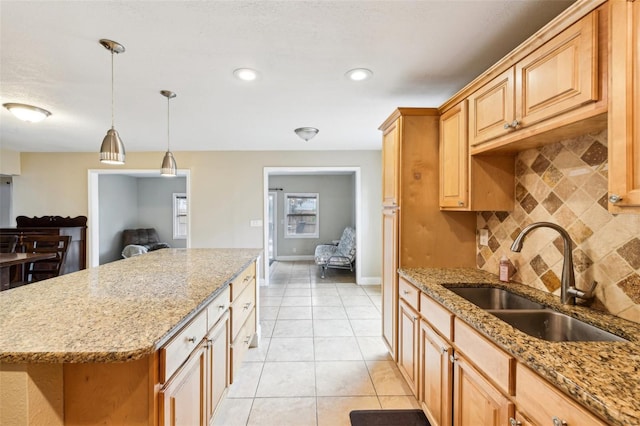 2260 Winslow Cir, Casselberry, FL 32707 - kitchen featuring a sink, a kitchen island, light tile patterned floors, backsplash, and pendant lighting