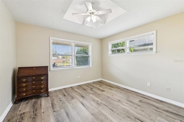 2260 Winslow Cir, Casselberry, FL 32707 - spare room featuring baseboards, a textured ceiling, ceiling fan, and wood finished floors