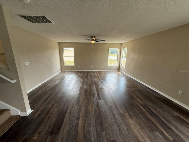 empty room with a textured ceiling, ceiling fan, visible vents, and stairway