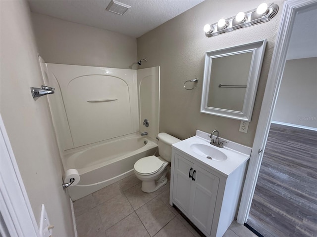 bathroom with visible vents, vanity, bathing tub / shower combination, toilet, and tile patterned floors