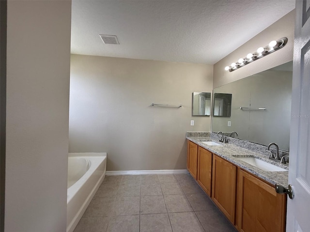 bathroom featuring baseboards, visible vents, a sink, and tile patterned floors