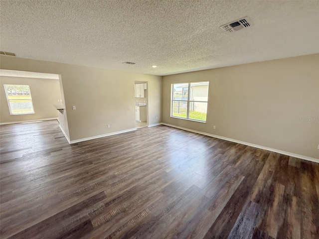 786 Crystal Bay Ln, Orlando, FL 32828 - unfurnished room featuring dark wood-style flooring, a textured ceiling, and visible vents