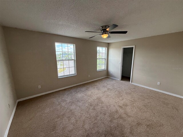 786 Crystal Bay Ln, Orlando, FL 32828 - unfurnished bedroom featuring carpet flooring, a textured ceiling, ceiling fan, and baseboards