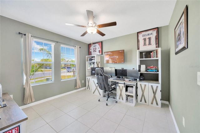 home office featuring baseboards, a ceiling fan, and light tile patterned flooring