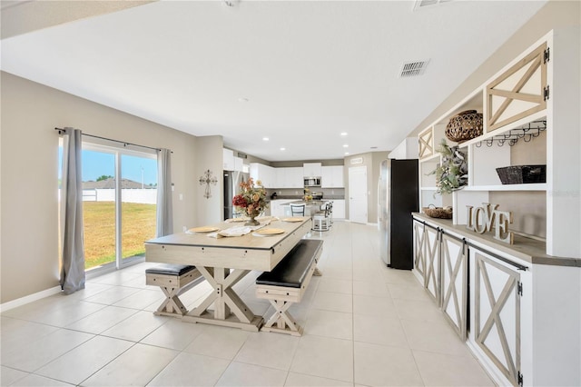 dining area featuring light tile patterned floors, baseboards, recessed lighting, and visible vents