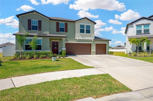 view of front of house featuring concrete driveway, an attached garage, a front lawn, and stucco siding
