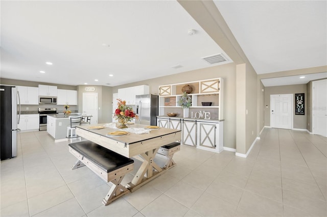 dining area with light tile patterned floors, baseboards, recessed lighting, and visible vents