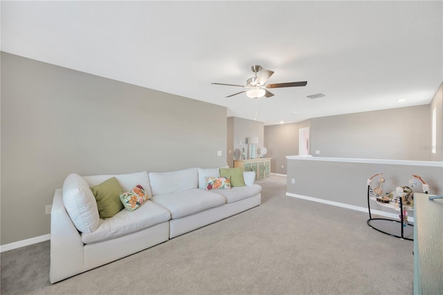 living area with baseboards, a ceiling fan, carpet flooring, and visible vents