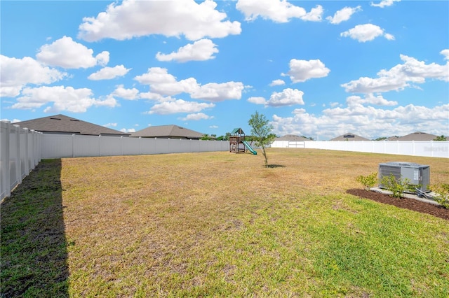 view of yard with a fenced backyard and a playground