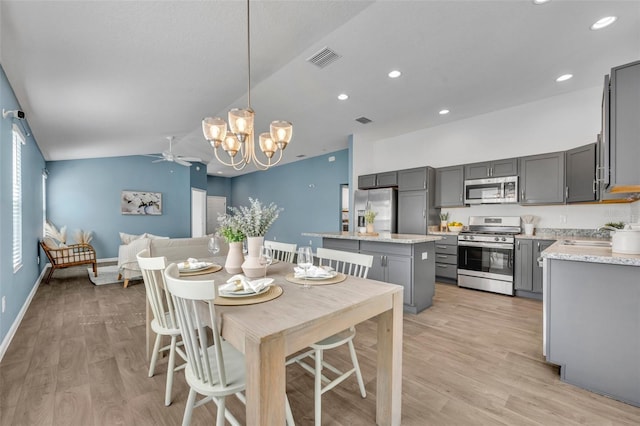 1397 Gatlin Pl, The Villages, FL 32163 - dining room featuring visible vents, recessed lighting, light wood finished floors, ceiling fan with notable chandelier, and vaulted ceiling