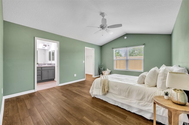 1397 Gatlin Pl, The Villages, FL 32163 - bedroom featuring a ceiling fan, wood finished floors, baseboards, lofted ceiling, and ensuite bath