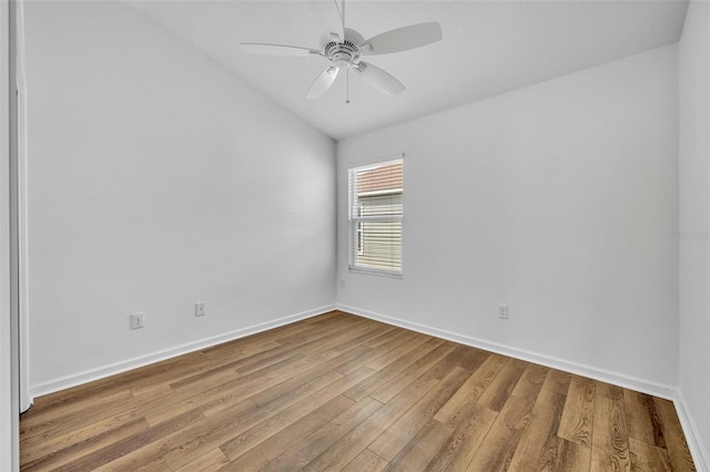 1397 Gatlin Pl, The Villages, FL 32163 - spare room with baseboards, a ceiling fan, vaulted ceiling, and wood finished floors