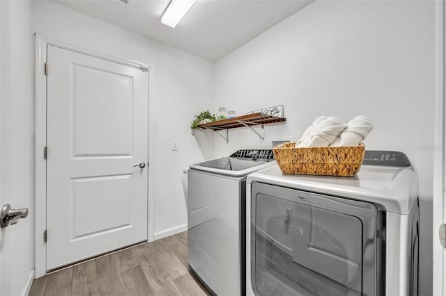 1397 Gatlin Pl, The Villages, FL 32163 - laundry room with baseboards, laundry area, washer and clothes dryer, and light wood-style flooring