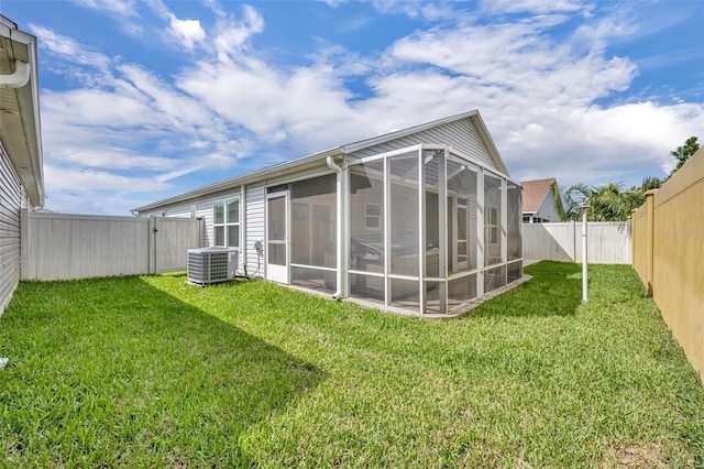 1397 Gatlin Pl, The Villages, FL 32163 - rear view of property with a sunroom, a fenced backyard, central AC, and a yard