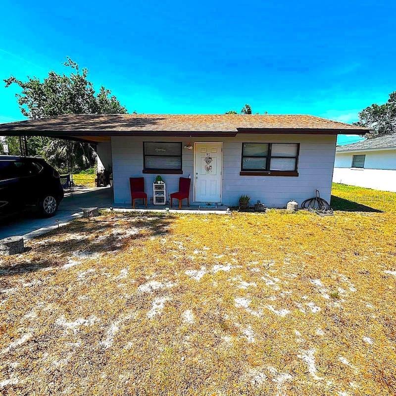 3015 Ave I NW, Winter Haven, FL 33881 - view of front facade with a carport and a front lawn